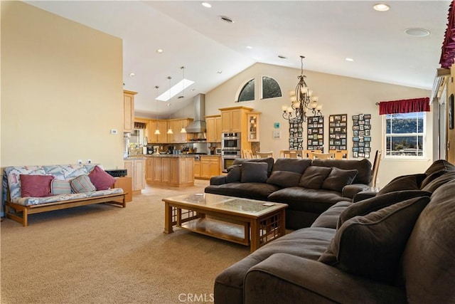 living area with a skylight, recessed lighting, light colored carpet, an inviting chandelier, and high vaulted ceiling