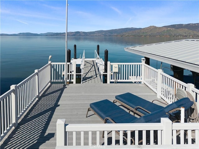 view of dock featuring a water and mountain view