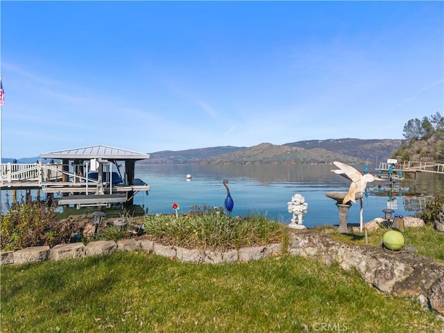 view of dock featuring boat lift and a water and mountain view