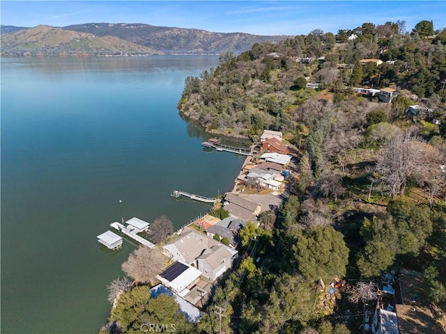 aerial view featuring a water and mountain view