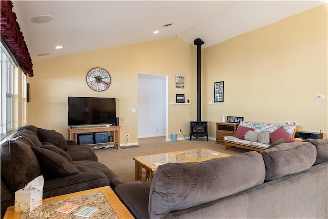 living room with baseboards, lofted ceiling, a wood stove, carpet flooring, and recessed lighting