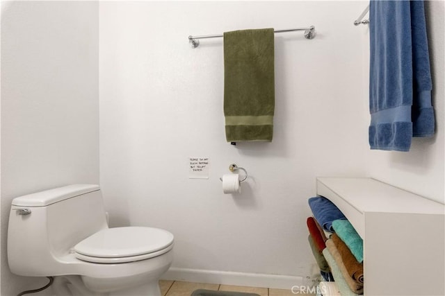 bathroom with tile patterned flooring, toilet, and baseboards