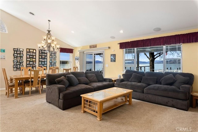 living area featuring vaulted ceiling, recessed lighting, light colored carpet, and a notable chandelier