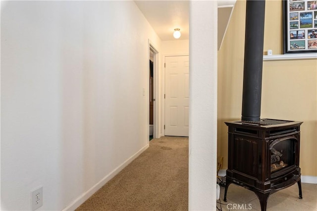 hallway featuring carpet floors and baseboards