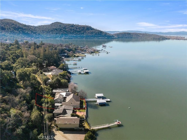 birds eye view of property featuring a water and mountain view