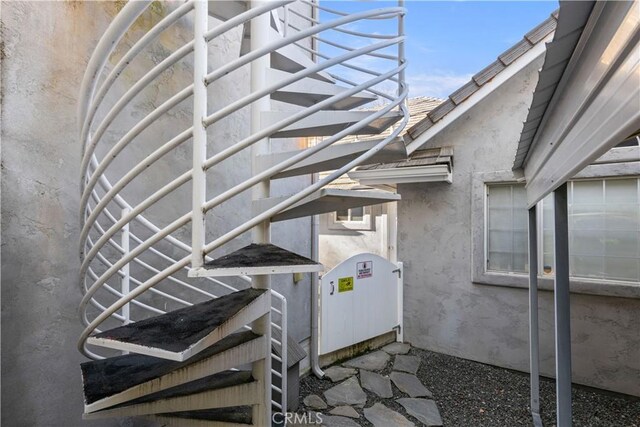 entrance to property featuring stucco siding