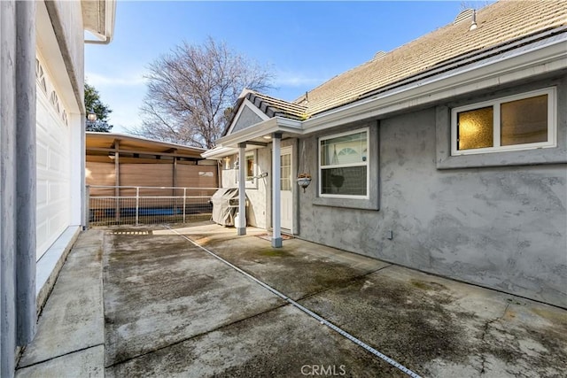 view of side of home with stucco siding