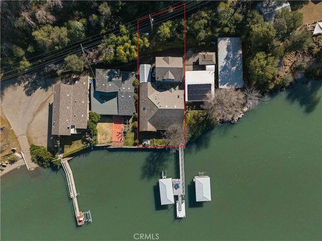 birds eye view of property with a water view