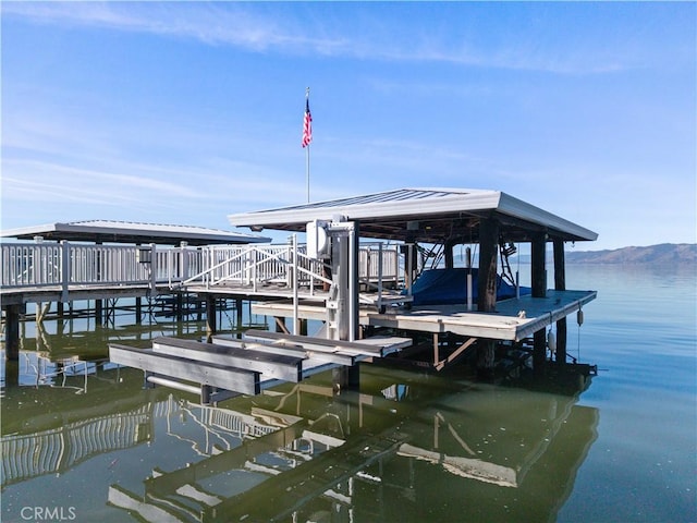 dock area with a water view and boat lift