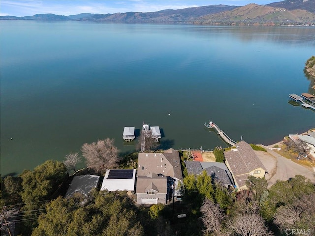 birds eye view of property with a water and mountain view