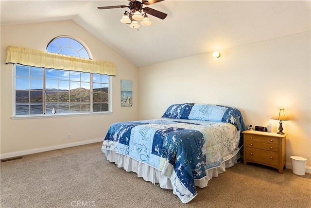 carpeted bedroom featuring lofted ceiling, ceiling fan, visible vents, and baseboards