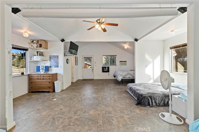 interior space featuring vaulted ceiling, ceiling fan, and multiple windows