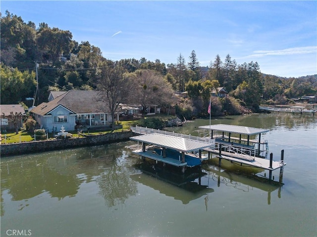 dock area with a water view and boat lift