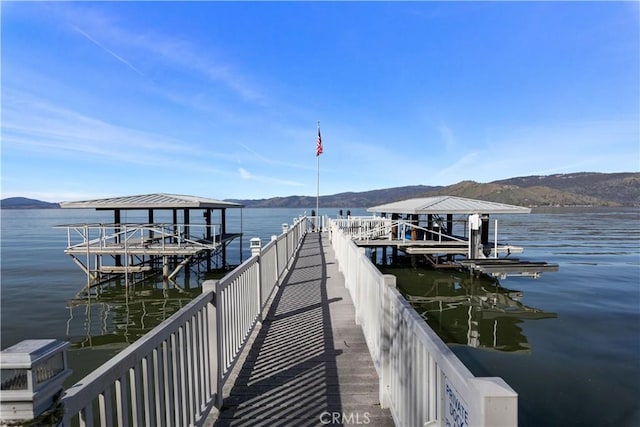 view of dock featuring a water and mountain view