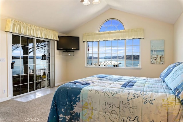 tiled bedroom featuring vaulted ceiling, access to outside, carpet flooring, and baseboards