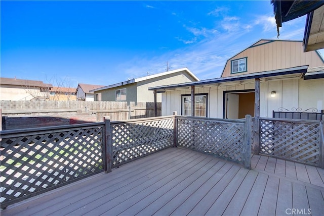 wooden terrace featuring fence