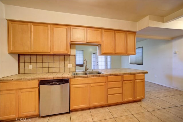 kitchen featuring a sink, light brown cabinets, tile counters, and stainless steel dishwasher