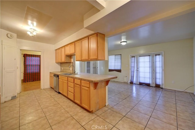 kitchen featuring tile countertops, light tile patterned floors, a sink, and dishwasher