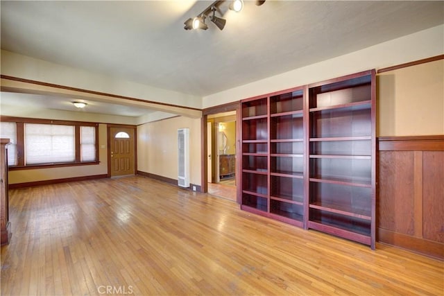 unfurnished room featuring hardwood / wood-style floors and baseboards