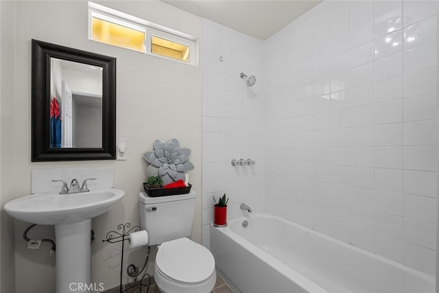 bathroom featuring shower / washtub combination and toilet