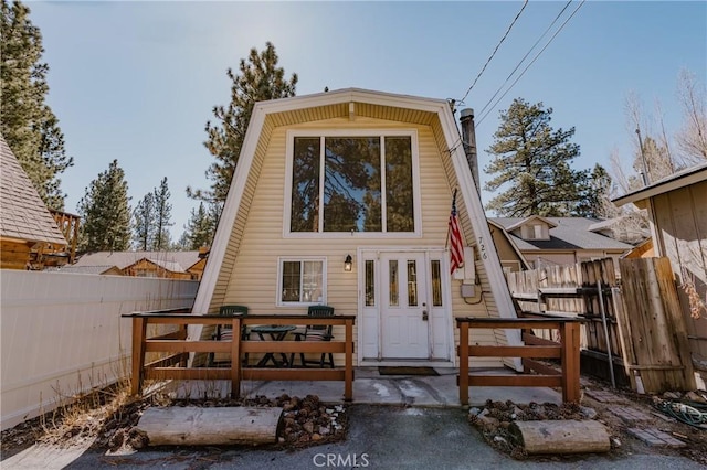 rear view of property featuring fence