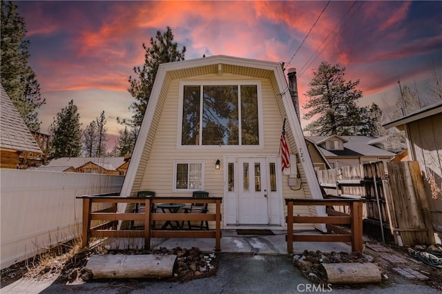 rear view of property featuring fence