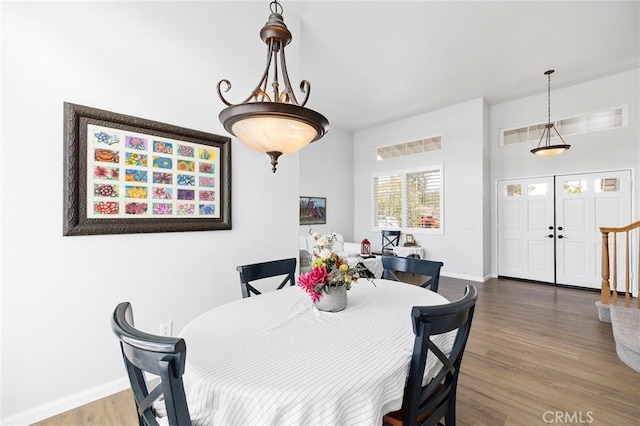 dining space with wood finished floors and baseboards