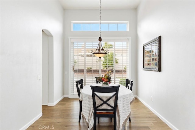 32388 Corte Palacio, Temecula, CA 92592 - dining space featuring a towering ceiling, baseboards, wood finished floors, and arched walkways
