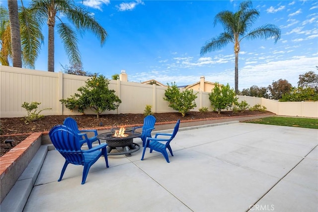 view of patio featuring a fenced backyard and a fire pit