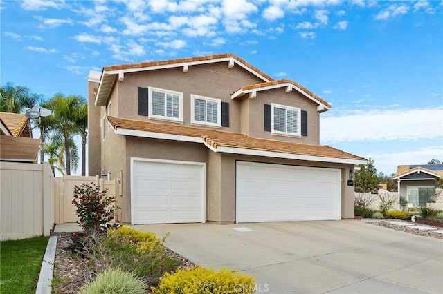 traditional home featuring a tile roof, stucco siding, an attached garage, fence, and driveway