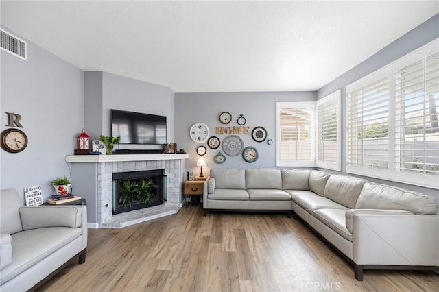 32388 Corte Palacio, Temecula, CA 92592 - living room featuring a brick fireplace and wood finished floors