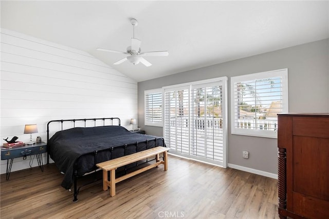 bedroom with baseboards, lofted ceiling, ceiling fan, access to exterior, and light wood-type flooring