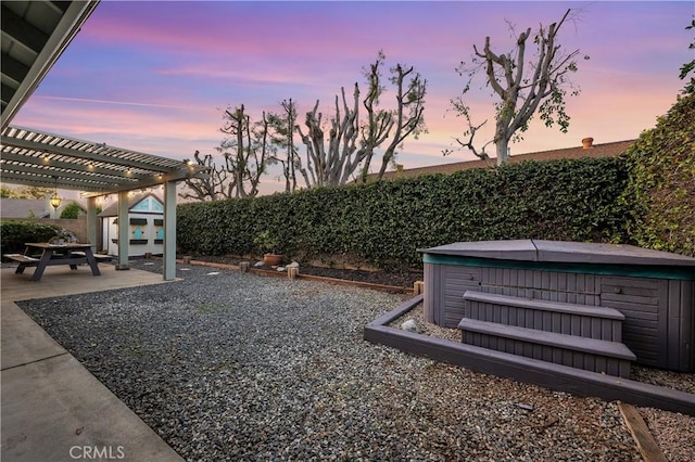 view of yard with a hot tub, a fenced backyard, a pergola, and a patio