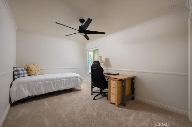 carpeted bedroom featuring ornamental molding, baseboards, and a ceiling fan