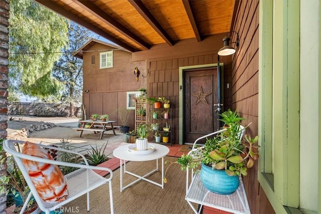 doorway to property featuring a patio and fence