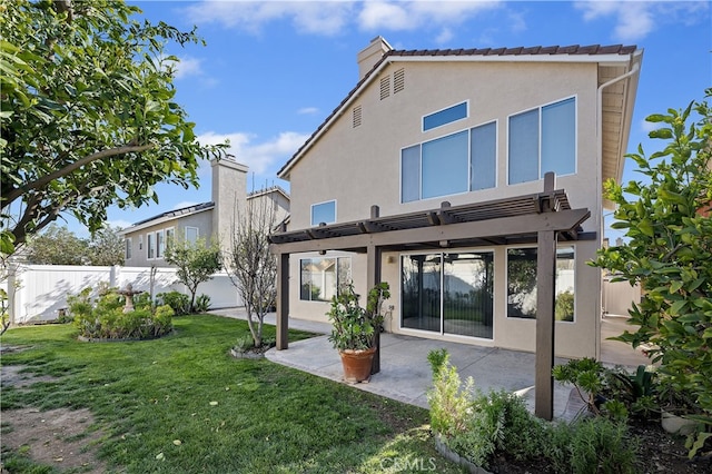 rear view of house with fence, a lawn, stucco siding, a pergola, and a patio area