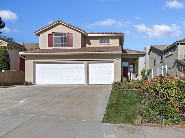 view of front of home with driveway, a tiled roof, and stucco siding