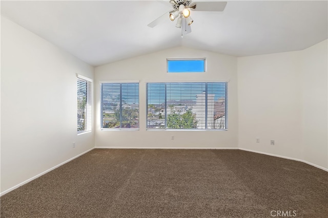 unfurnished room with dark carpet, vaulted ceiling, baseboards, and ceiling fan