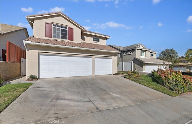 traditional-style house with stucco siding, an attached garage, fence, driveway, and a tiled roof