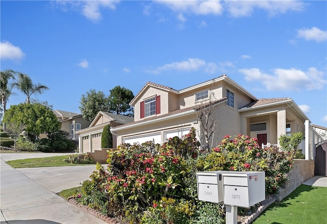 view of front facade with a garage, a tile roof, driveway, and stucco siding