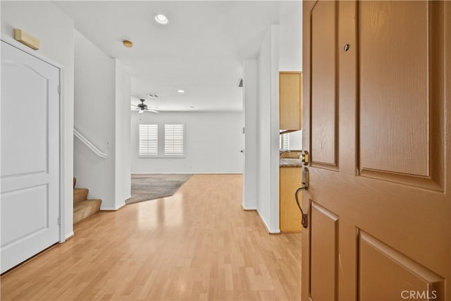 entryway with ceiling fan, stairway, light wood-style flooring, and recessed lighting