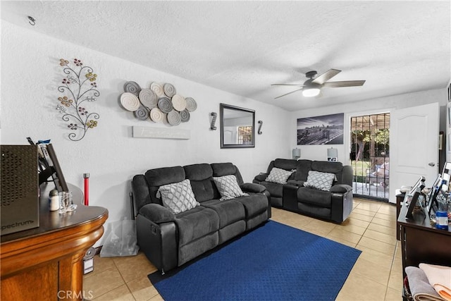 living area featuring a textured ceiling, light tile patterned flooring, and a ceiling fan