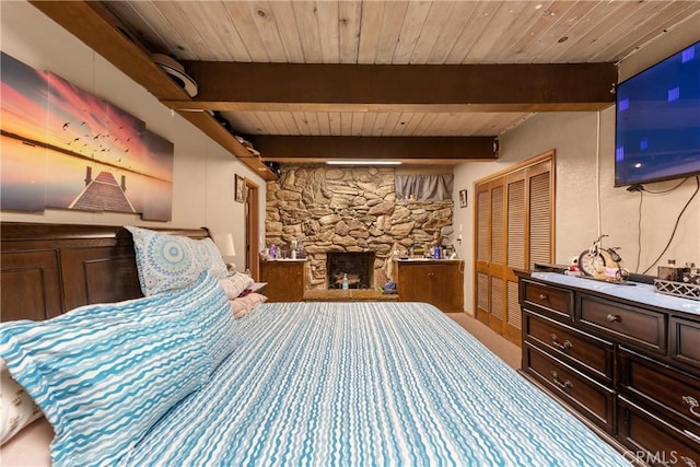 bedroom with wood ceiling, a fireplace, and beam ceiling