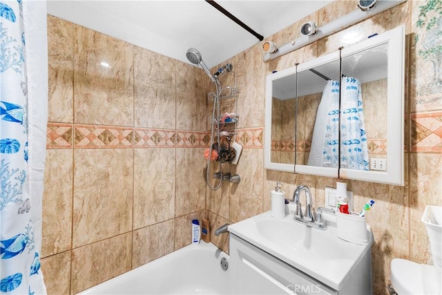 full bathroom featuring shower / tub combo, tile walls, vanity, and toilet