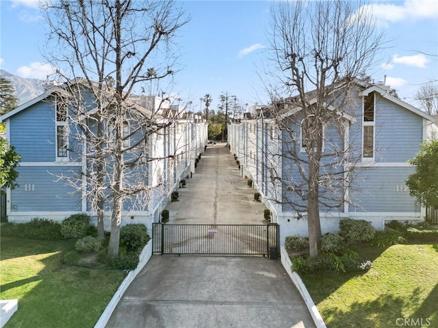 view of property exterior featuring a gate and a yard