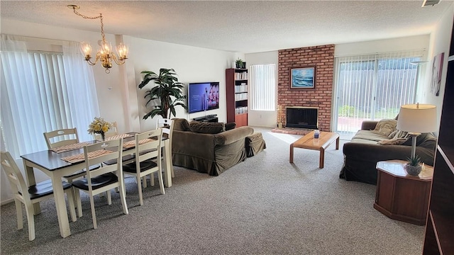 carpeted living room with a notable chandelier, a fireplace, and a textured ceiling