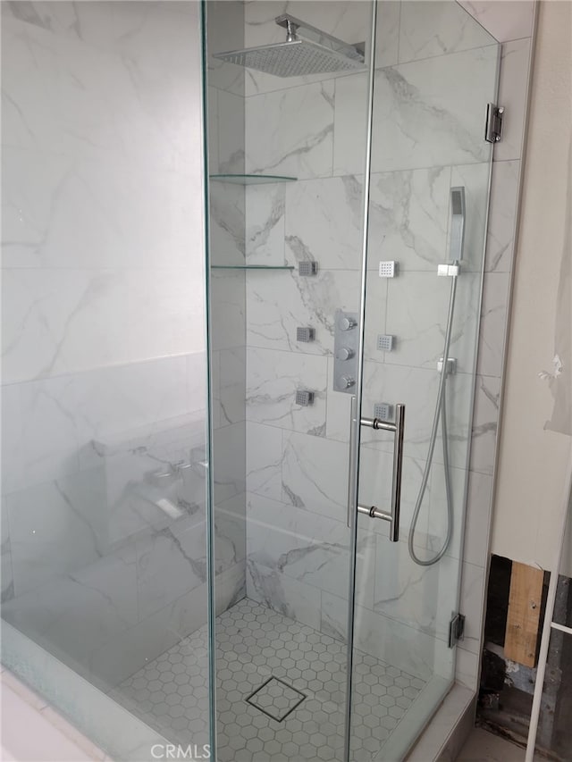 full bath with a marble finish shower