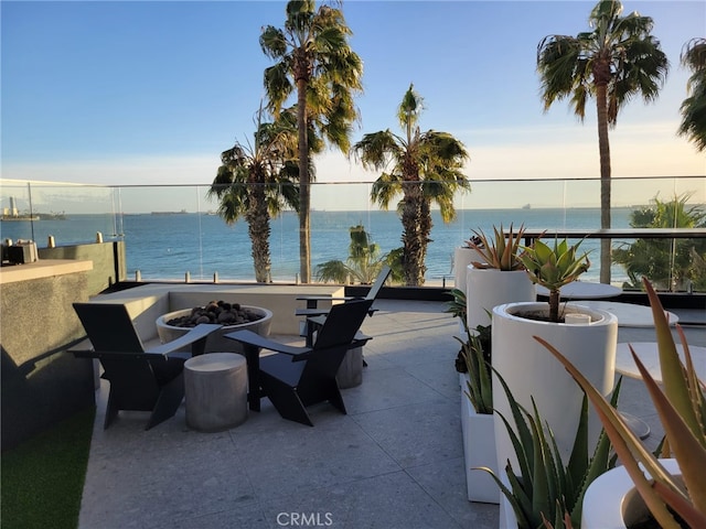 view of patio featuring a fire pit and a water view