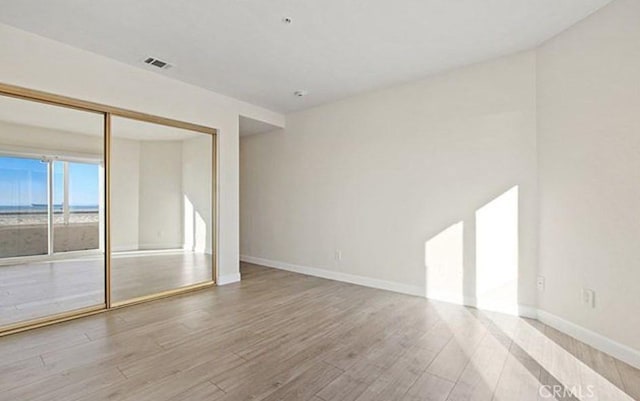 25 15th Pl Unit 101, Long Beach, CA 90802 - spare room with wood finished floors, baseboards, and a water view