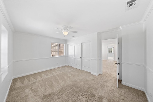 unfurnished bedroom with carpet, a closet, visible vents, and baseboards